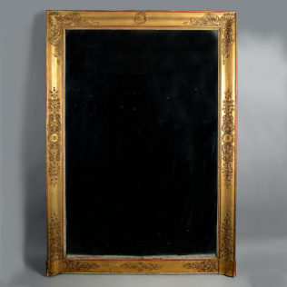 An early 19th century empire period large gilt wood overmantel mirror