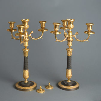 A pair of early 19th century charles x ormolu and bronze candelabra
