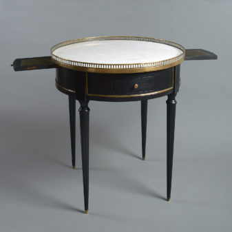 A late 19th century ebonised empire style bouillotte table