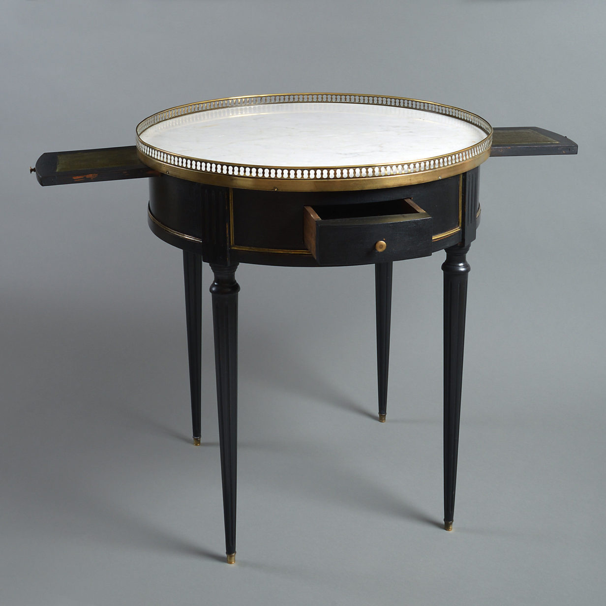 A late 19th century ebonised empire style bouillotte table