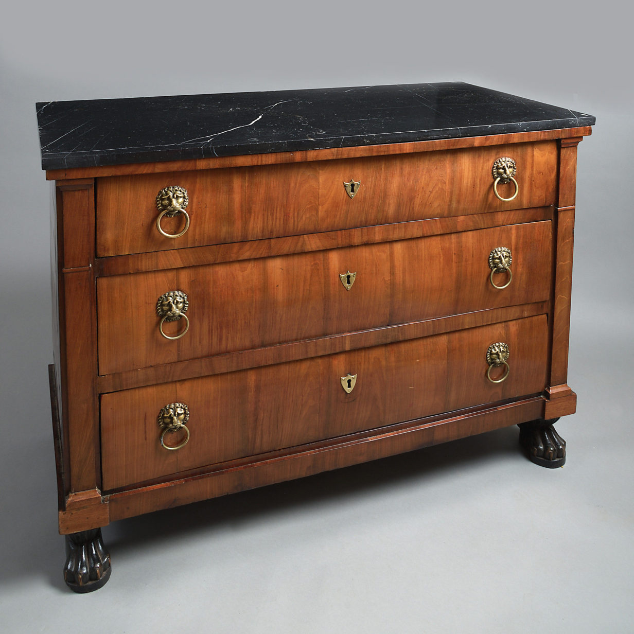 An early 19th century empire period walnut commode
