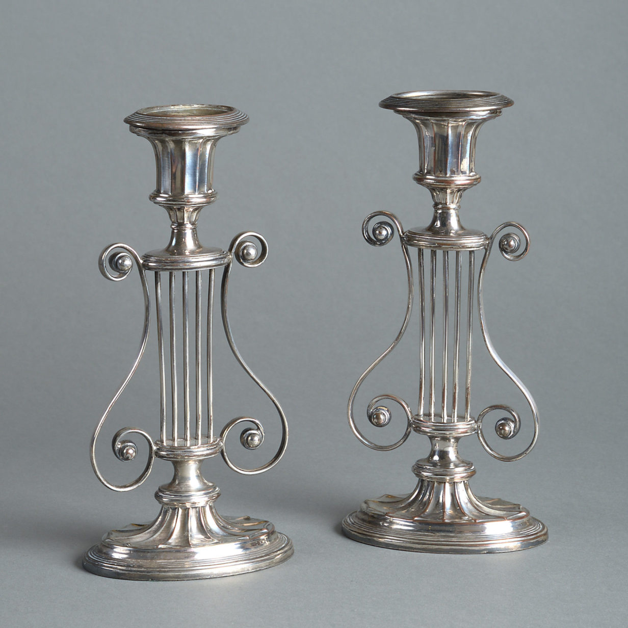 A pair of early 19th century sheffield plate candlesticks