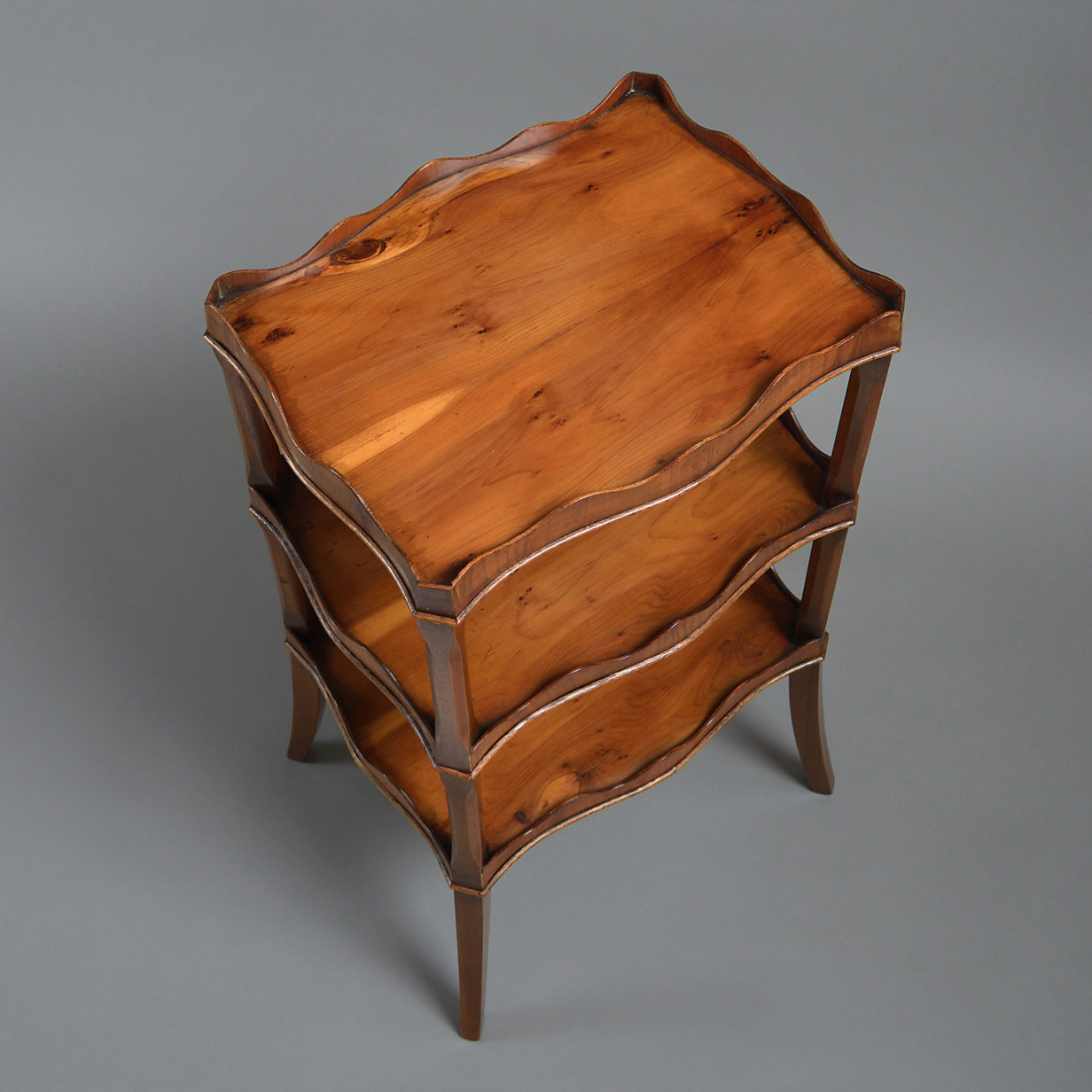 A late 19th century yew wood three tier etagere