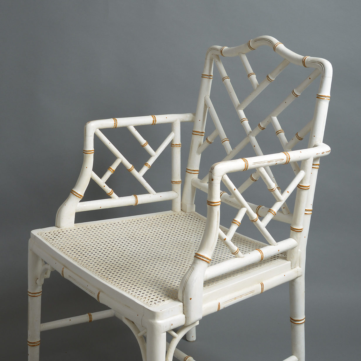20th century pair of painted faux bamboo cockpen open armchairs