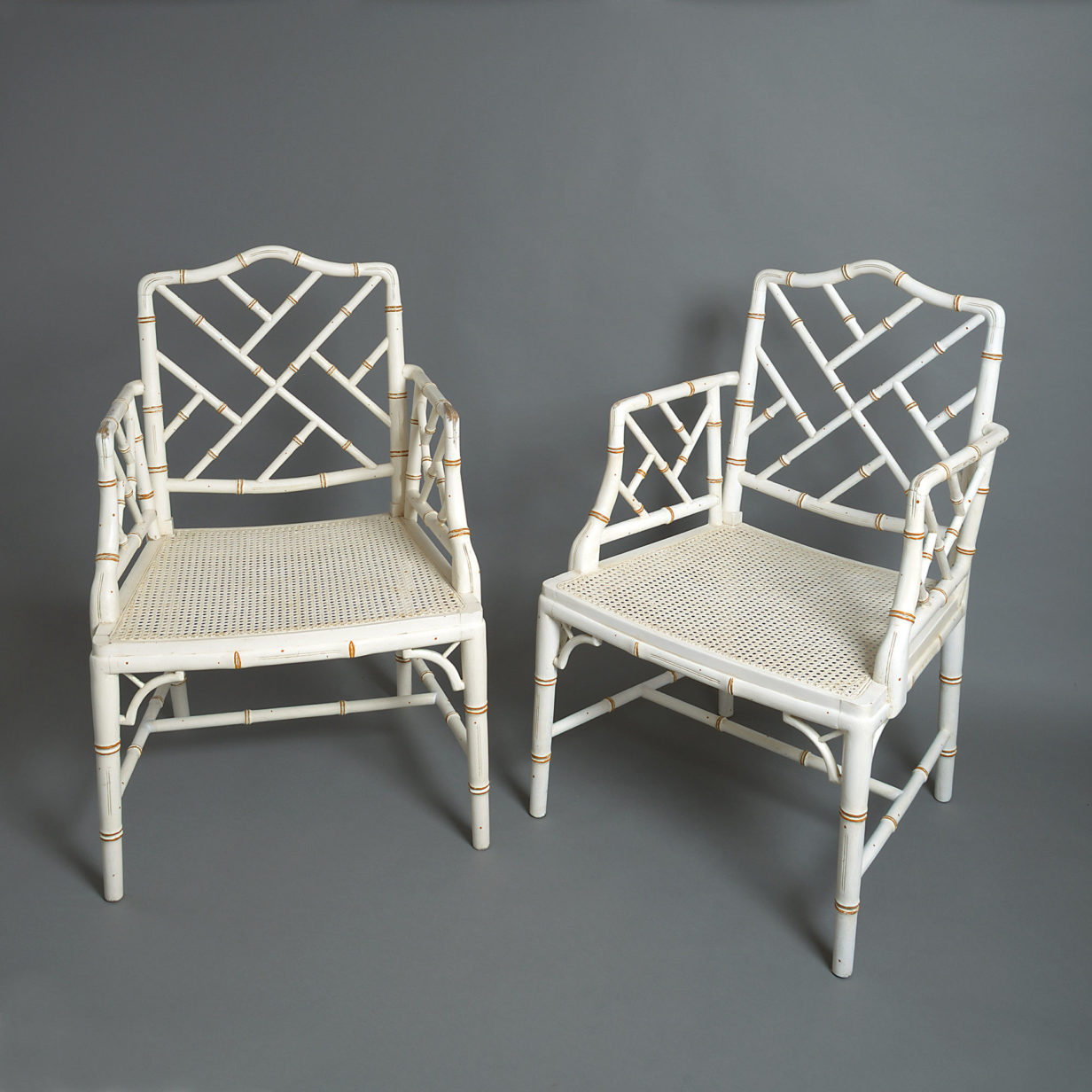 20th century pair of painted faux bamboo cockpen open armchairs