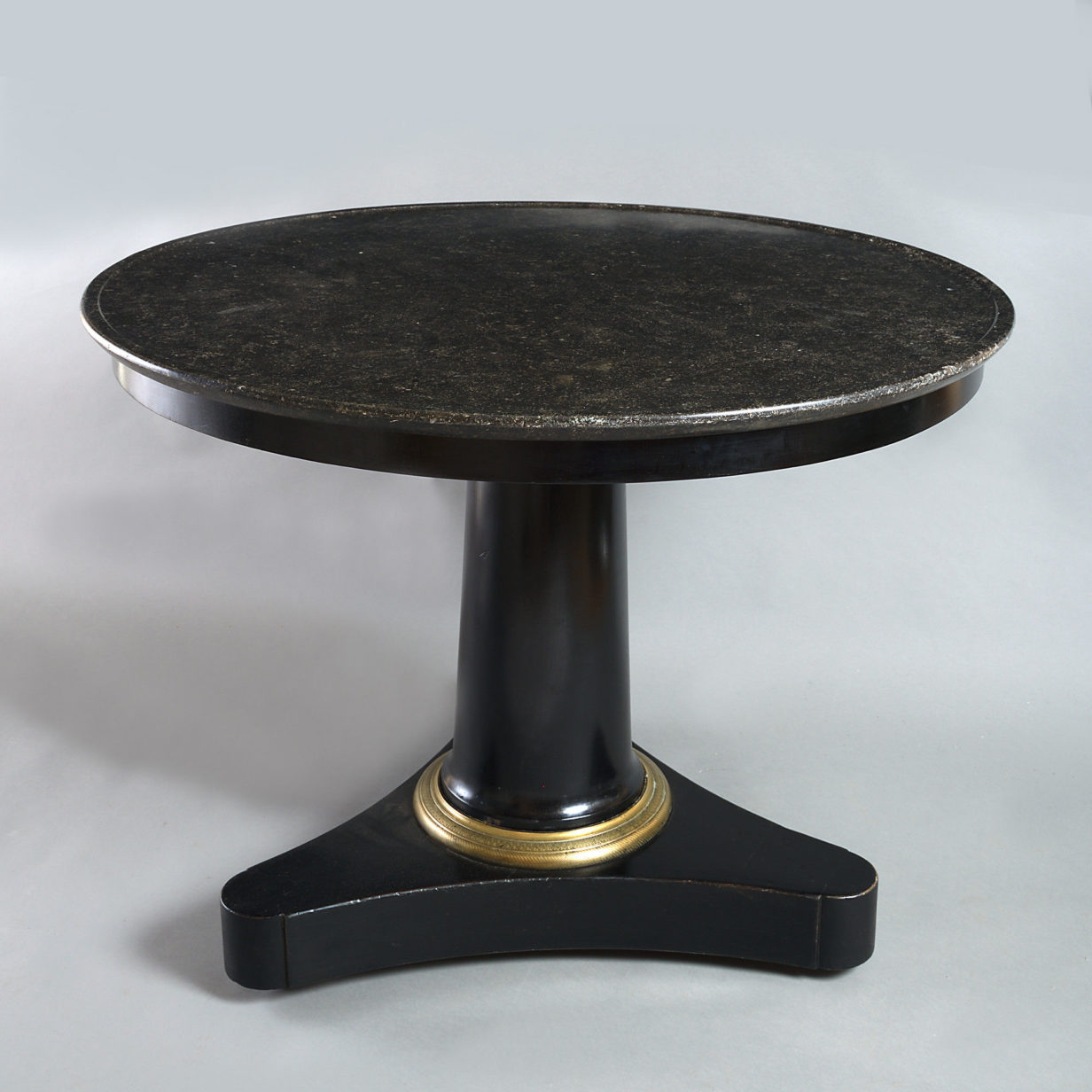 Early 19th century empire period ebonised circular centre table