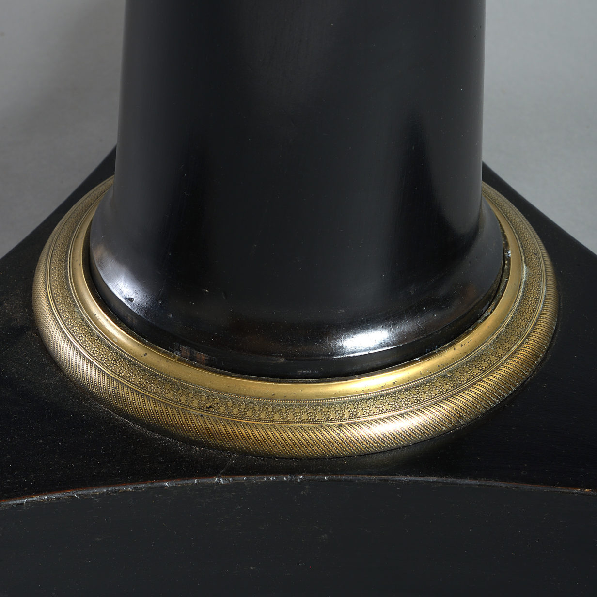 Early 19th century empire period ebonised circular centre table
