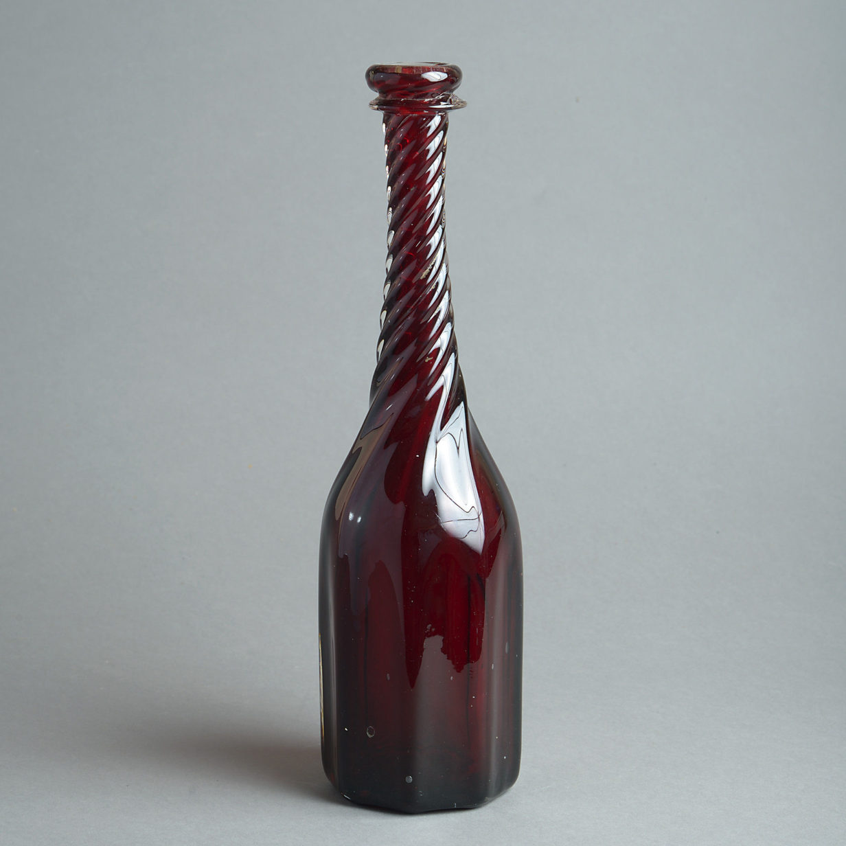Mid-19th century red wrythen glass bottle