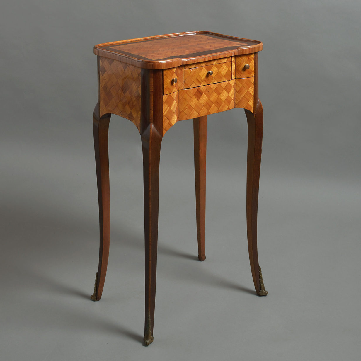 A pair of parquetry bedside cabinets