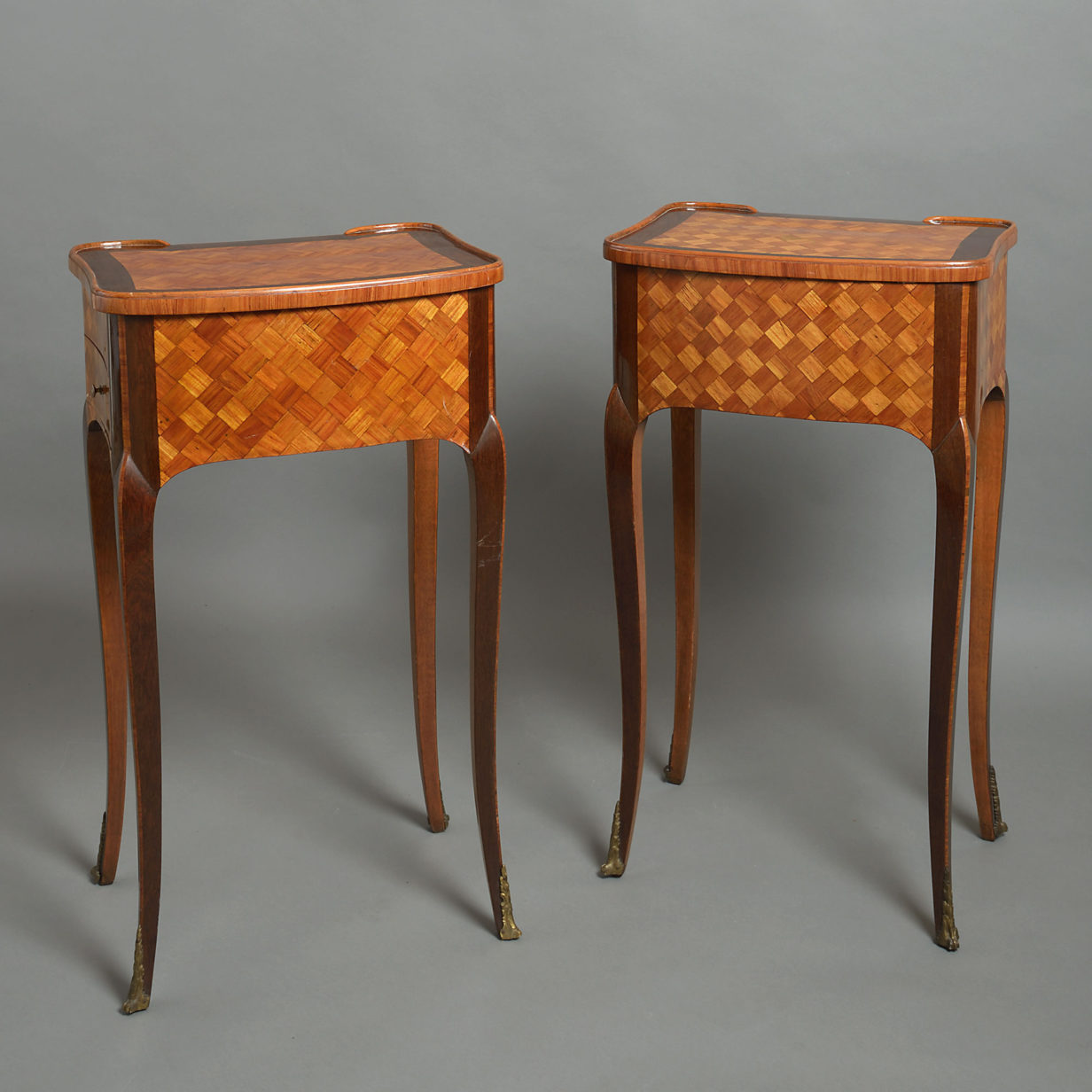 A pair of parquetry bedside cabinets