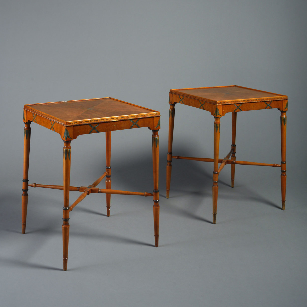 A pair of satinwood end tables in the sheraton taste