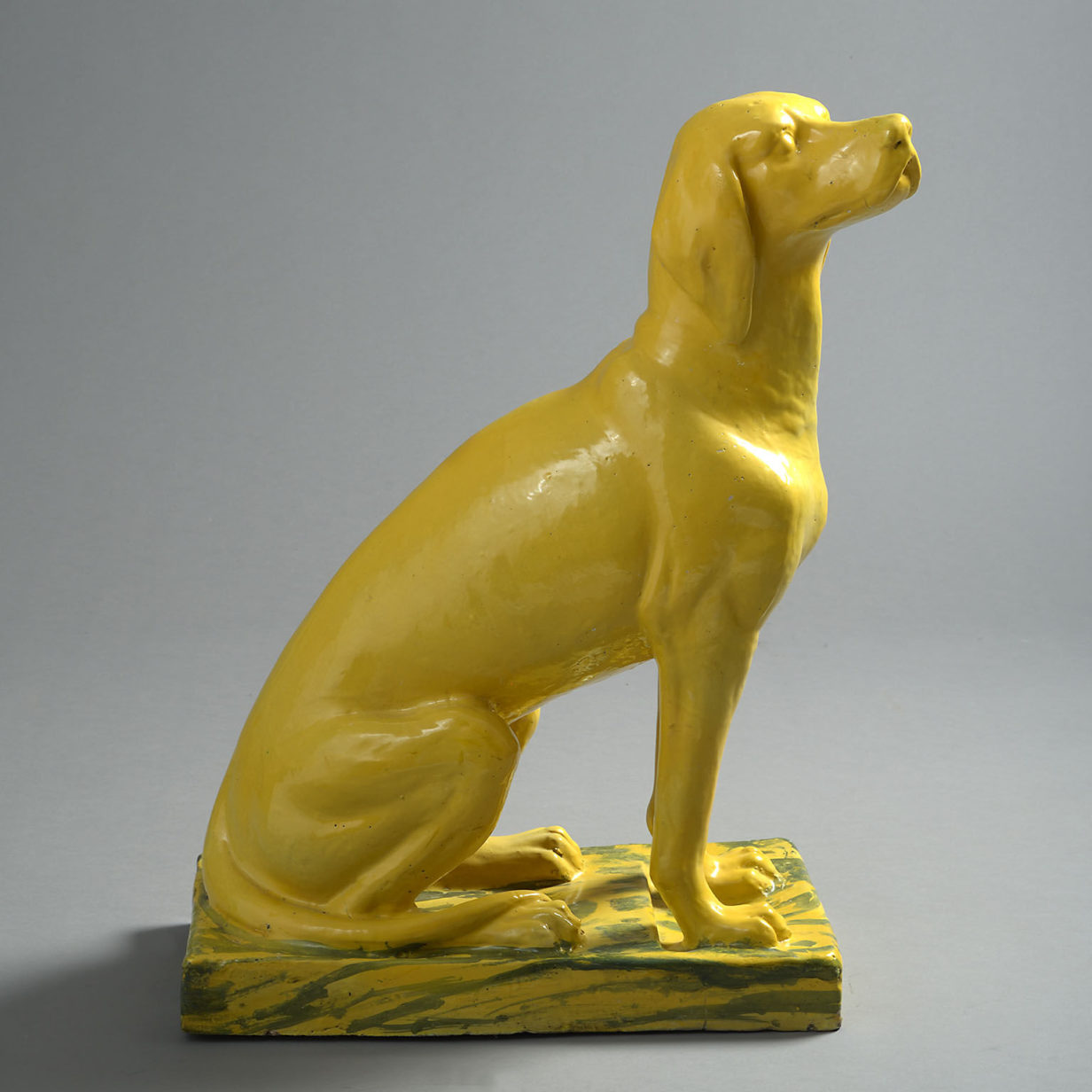 Lifesize bright yellow ceramic statue of a pointer dog