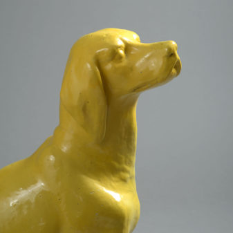 Lifesize bright yellow ceramic statue of a pointer dog