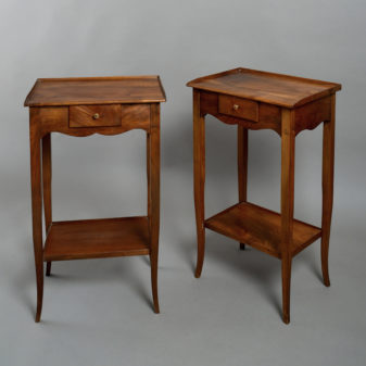 A pair of walnut bedside tables in the louis xv manner