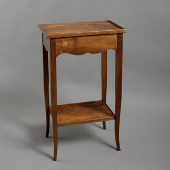 A pair of walnut bedside tables in the louis xv manner