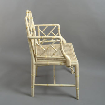 A mid-20th century pair of painted chinoiserie cockpen armchairs