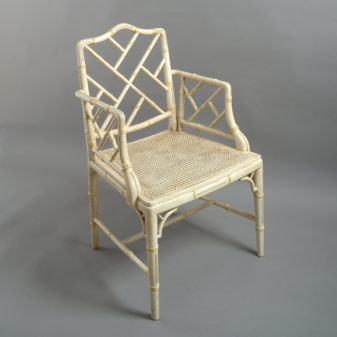 A mid-20th century pair of painted chinoiserie cockpen armchairs