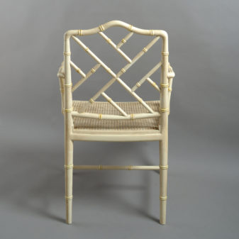 A mid-20th century pair of painted chinoiserie cockpen armchairs