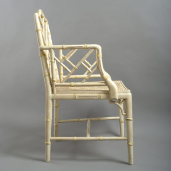 A mid-20th century pair of painted chinoiserie cockpen armchairs