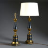 A pair of black and gilt tole table lamps