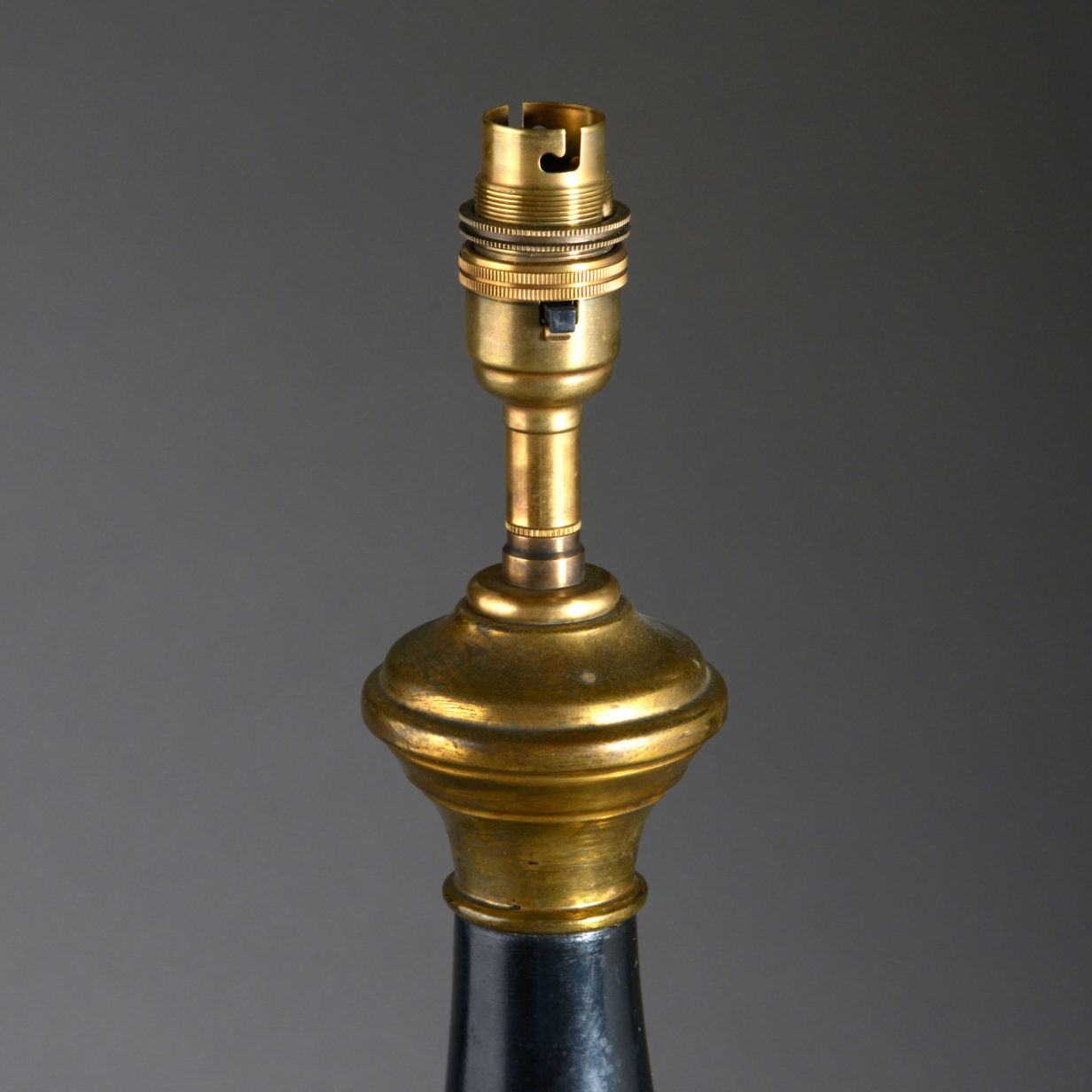 A pair of black and gilt tole table lamps