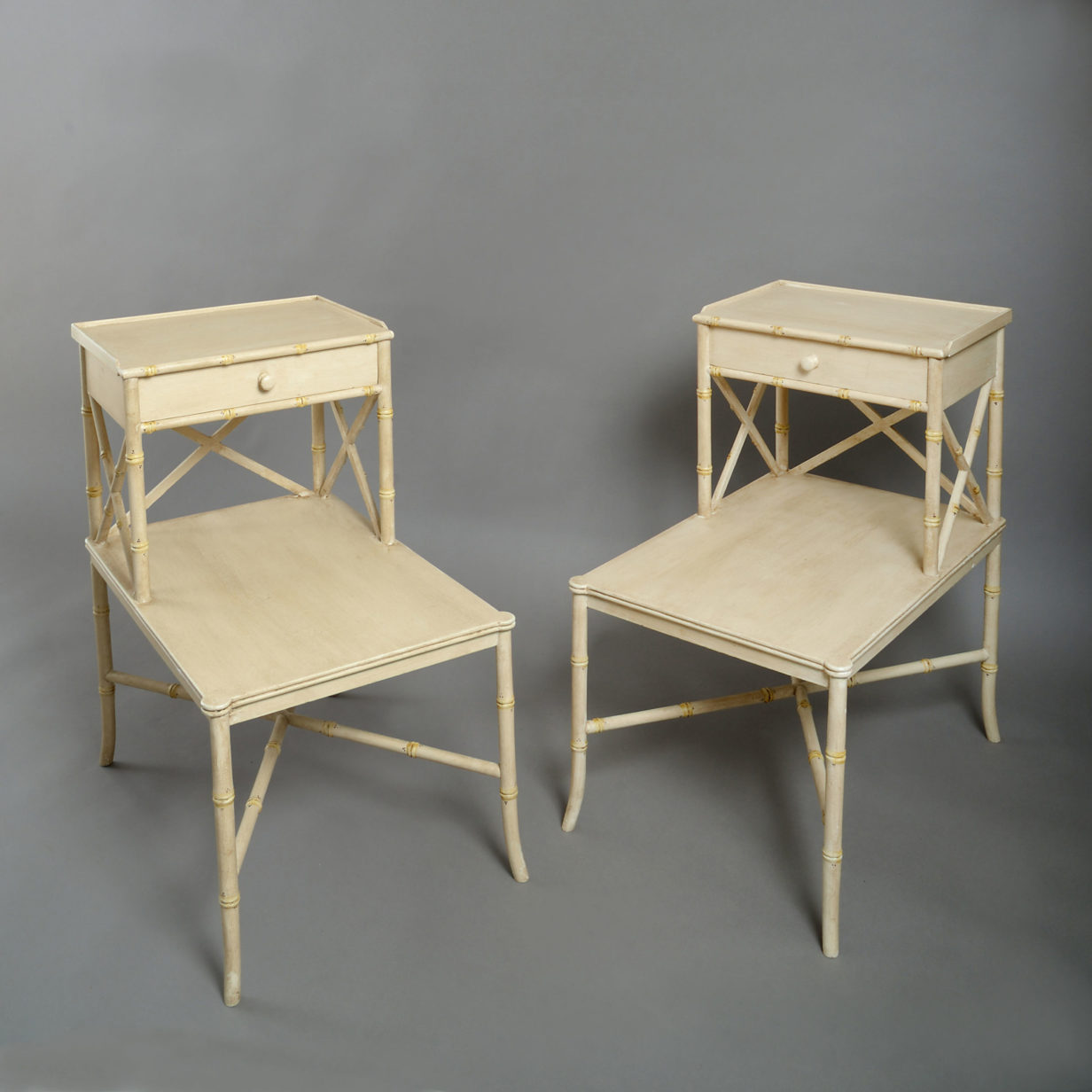A pair of faux bamboo bedside tables