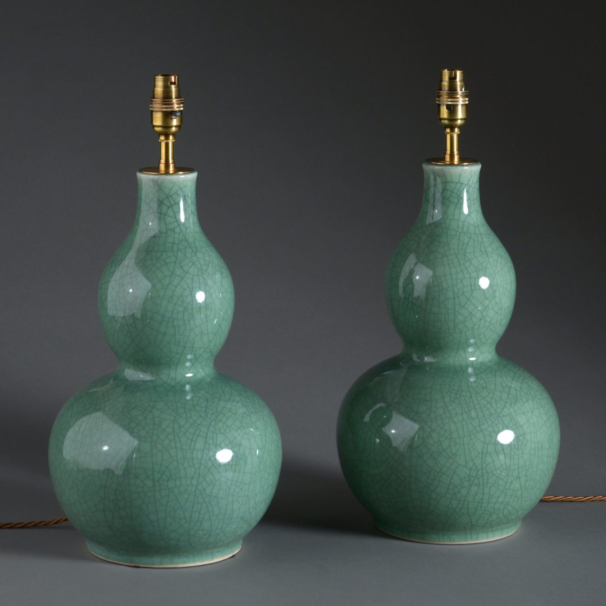 A pair of celadon porcelain gourd shaped vase lamps