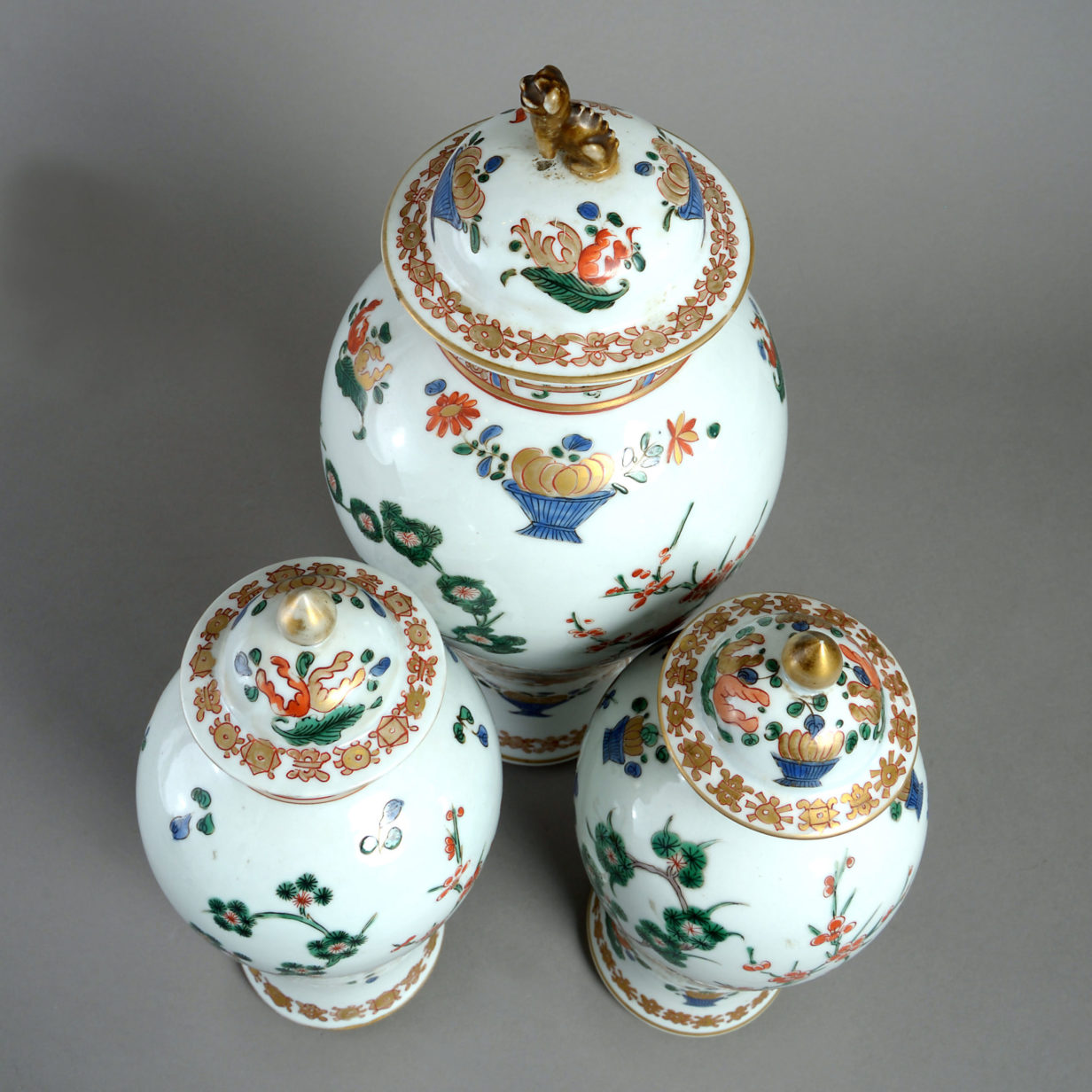 A garniture of three 19th century samson vases & covers