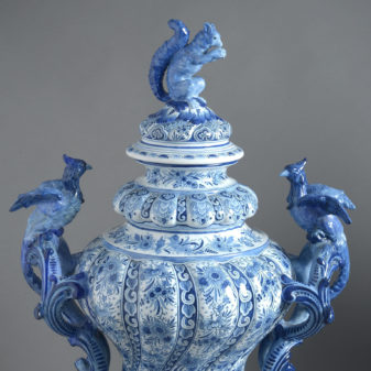 A large pair of rococo revival delft lidded vases