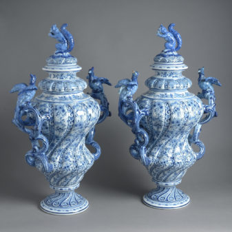 A large pair of rococo revival delft lidded vases