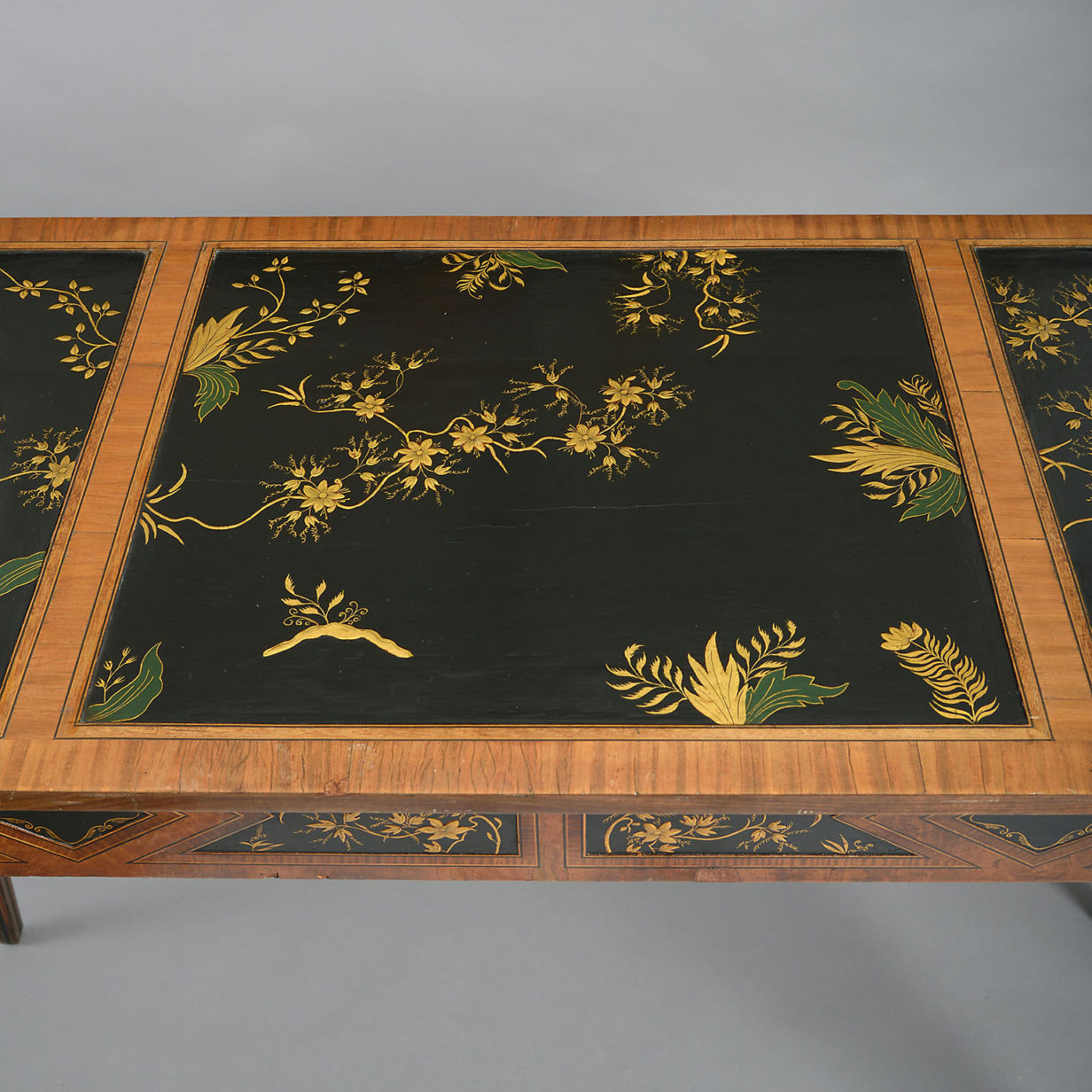 An 18th century satinwood side table inset with lacquer panels