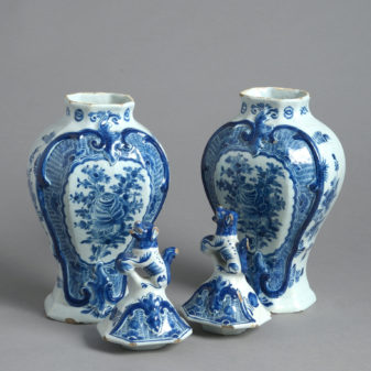 A pair of signed 18th century delft lidded vases