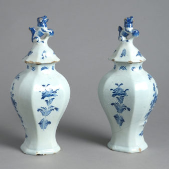 A pair of signed 18th century delft lidded vases