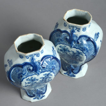 A pair of signed 18th century delft lidded vases