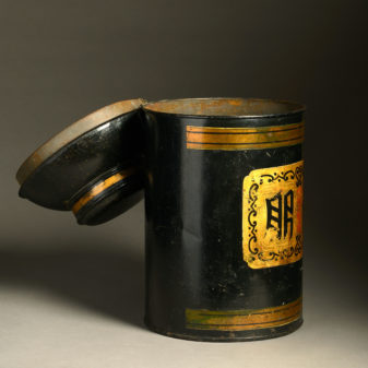 A 19th century black painted tole tea canister