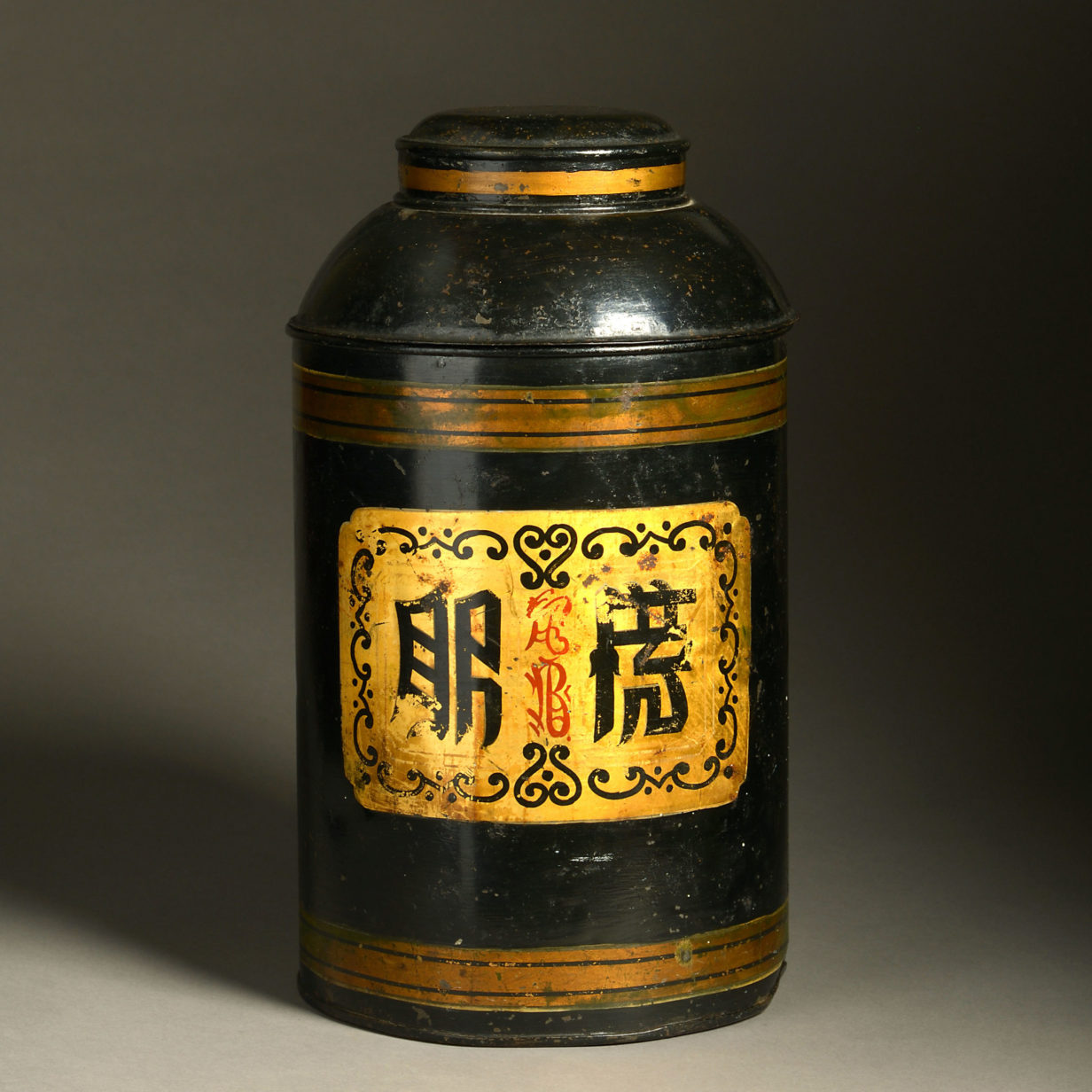 A 19th century black painted tole tea canister