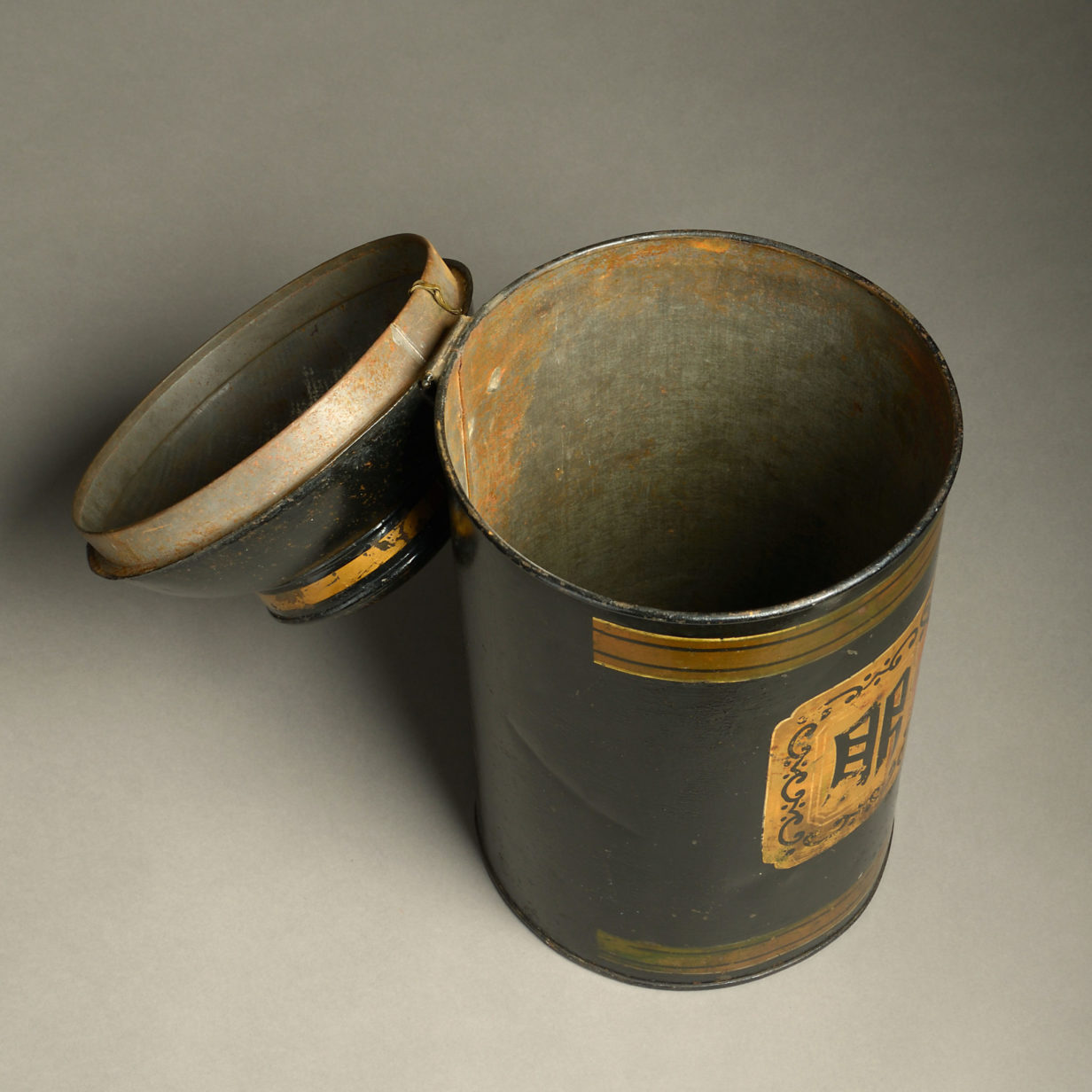 A 19th century black painted tole tea canister