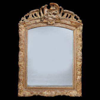 An early 18th century louis xv period giltwood mirror