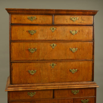 An early 18th century queen anne period walnut chest on stand