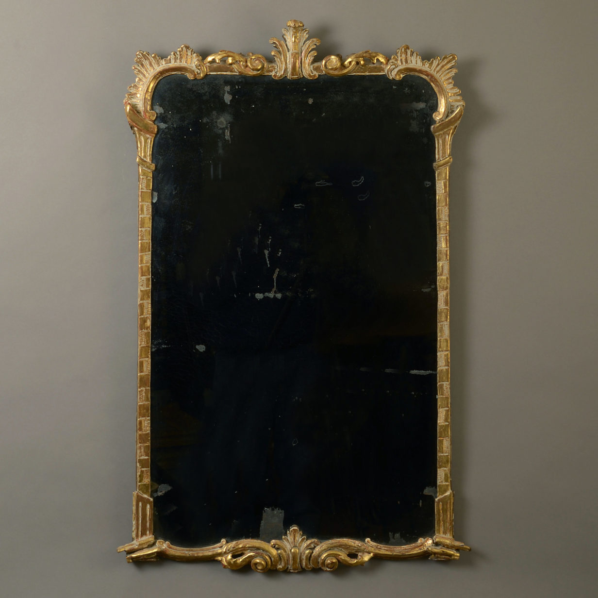 A mid-18th century irish george iii carved giltwood mirror