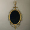 A late 18th century george iii adam period oval giltwood mirror