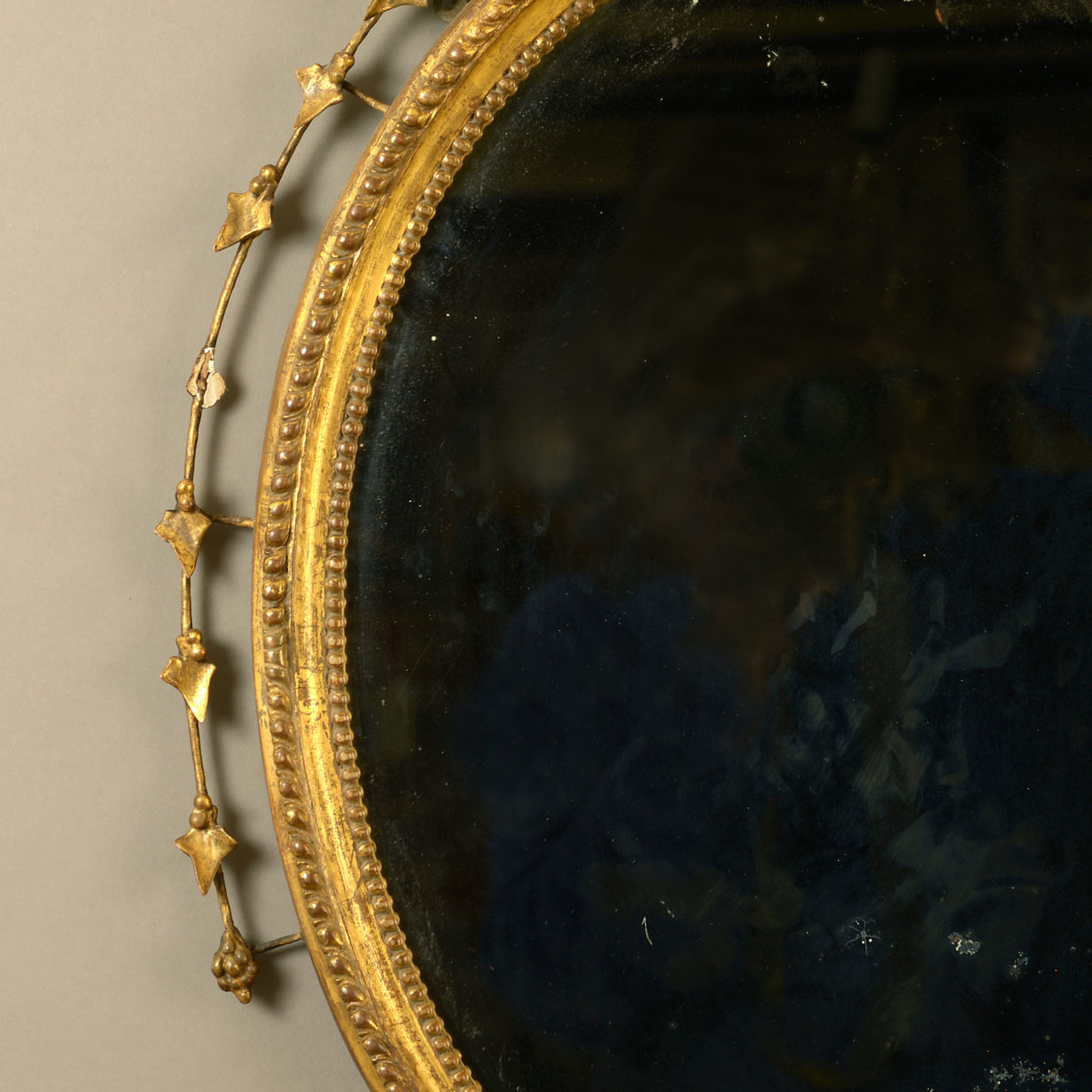 A late 18th century george iii adam period oval giltwood mirror