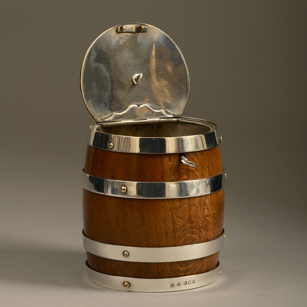A 19th century oak and silvered barrel tobacco jar
