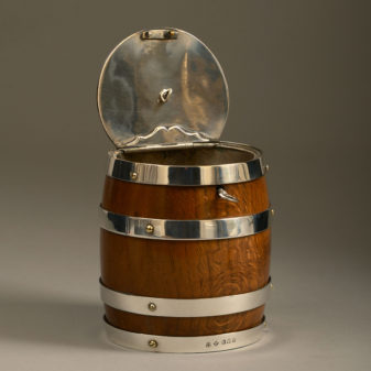 A 19th century oak and silvered barrel tobacco jar