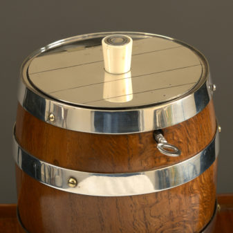 A 19th century oak and silvered barrel tobacco jar