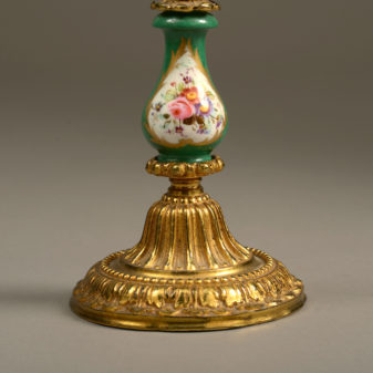 A 19th century pair of sevres and ormolu candlesticks