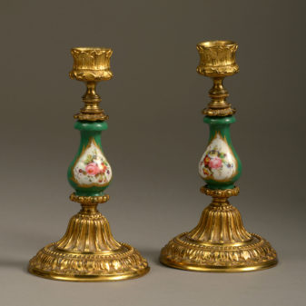 A 19th century pair of sevres and ormolu candlesticks