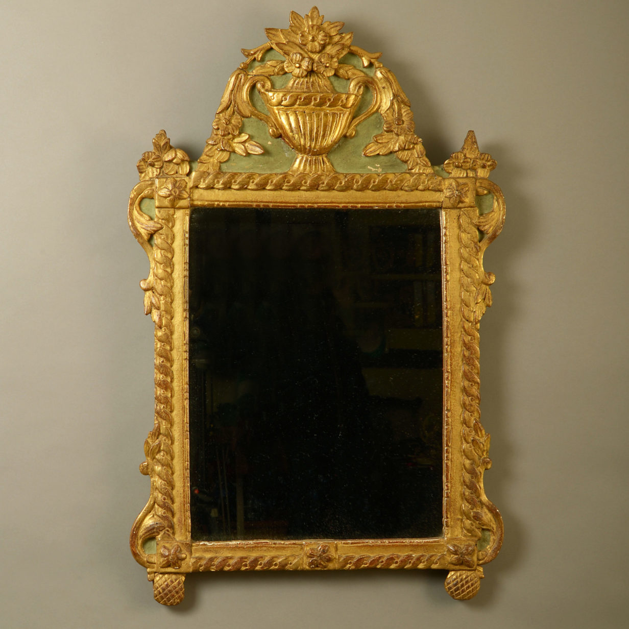 An early 20th century painted parcel gilded mirror in the louis xvi manner