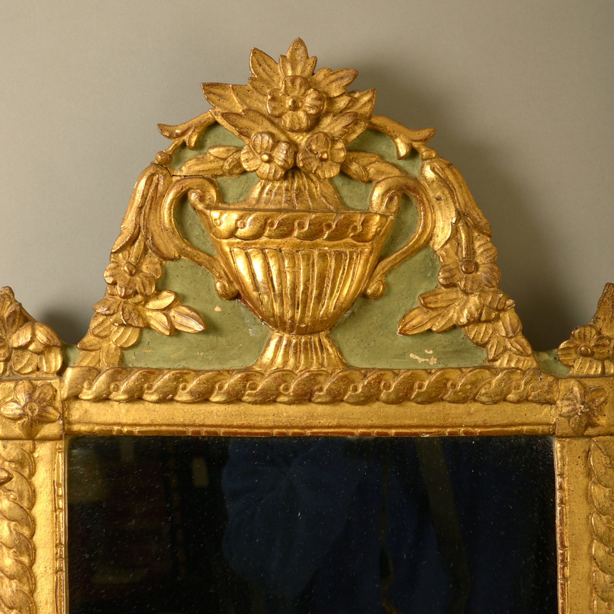 An early 20th century painted parcel gilded mirror in the louis xvi manner