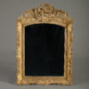 An early 18th century louis xv period giltwood mirror